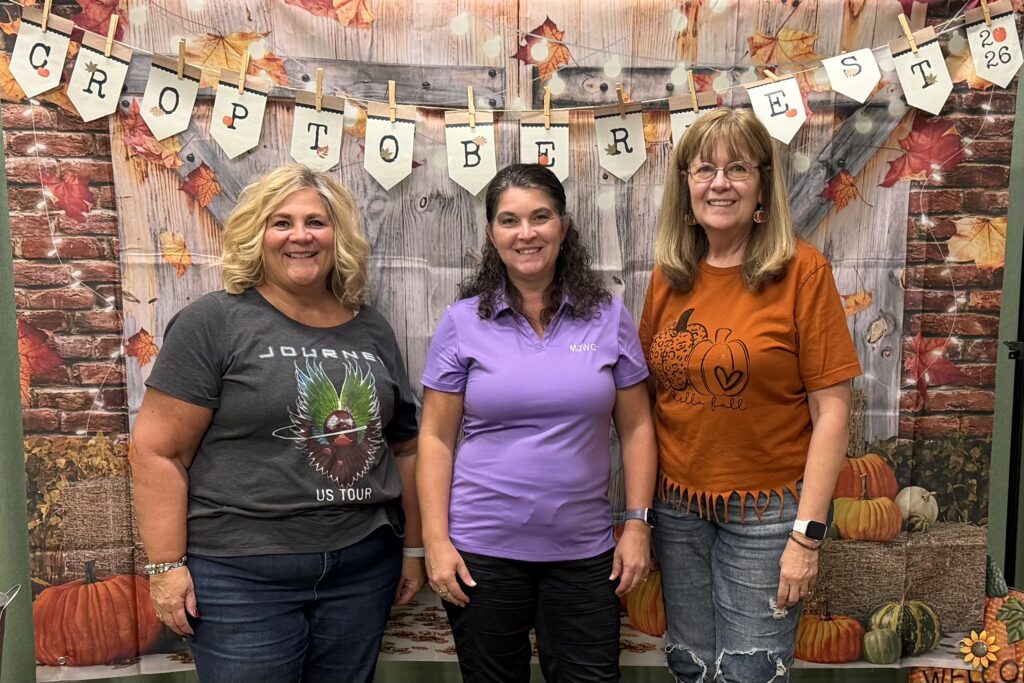 Three Munster Junior Woman's Club members attending Croptoberfest 2026, a full-day scrapbooking event celebrating creativity and fellowship.